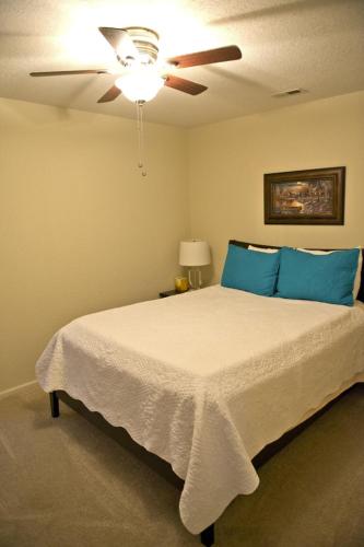 a bedroom with a bed with a ceiling fan at Spacious 3 BR Ozark Penthouse in Four Seasons