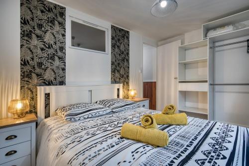une chambre avec un lit avec deux serviettes dessus dans l'établissement Alicia - Appartement RDC - Parking gratuit, à Concarneau
