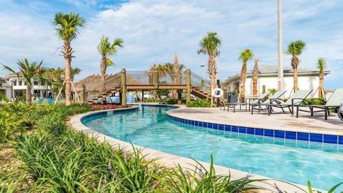 a pool at a resort with palm trees at 2940 - Elegant 5BR Villa at Storey Lake Resort Comfort Luxury and Proximity Disney and Universal in Kissimmee