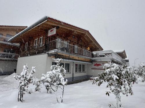 a house with snow on the ground in front of it at Swiss Chalet Holidays Ringgenberg in Ringgenberg