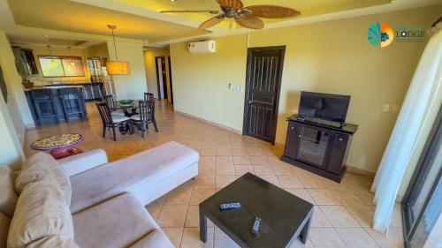 a living room with a couch and a tv at Vista Condor Lodge in Puerto Viejo