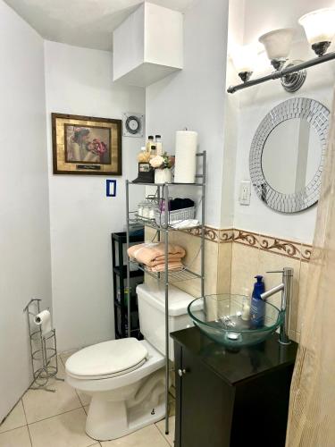 a bathroom with a toilet and a sink and a mirror at BK Studio 422 in Brooklyn