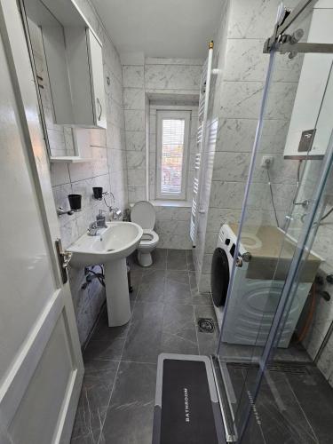 a small bathroom with a sink and a toilet at Apartman Begovic in Kolašin