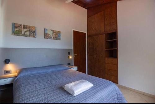 a bedroom with a bed with a white pillow on it at Soles del lago in Villa Carlos Paz