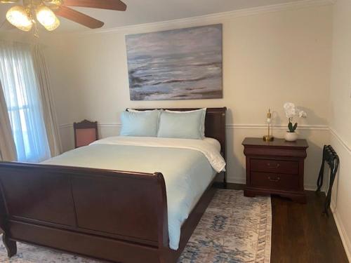 a bedroom with a large bed and a ceiling fan at Lrge 5 BR 9 Beds Near DC-Pool, Hot Tub, Gym, Game Rm, Fire Pit in Bowie