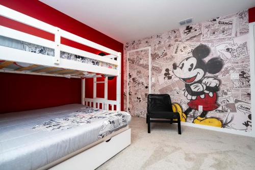 a bedroom with a mickey mouse mural on the wall at Luxury 3 Bed Home up to 8 guests- The Hub - 3236 TT in Orlando