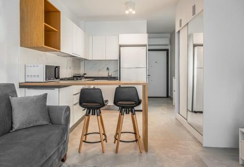 a living room with a couch and a kitchen at Sophia Pool Apartments in Caesar Blue Resort, Fixed Lunch till 3pm, Gym, Swimming Pools, Sauna, Hammam, Kids' club available in Perivolia tou Trikomou