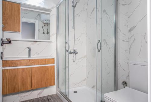 a bathroom with a shower and a toilet at Sophia Pool Apartments in Caesar Blue Resort, Fixed Lunch till 3pm, Gym, Swimming Pools, Sauna, Hammam, Kids' club available in Perivolia tou Trikomou