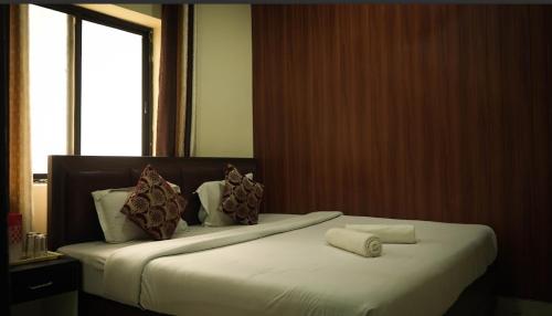 a hotel room with two beds with towels on them at Moksh Ganga in Rishīkesh