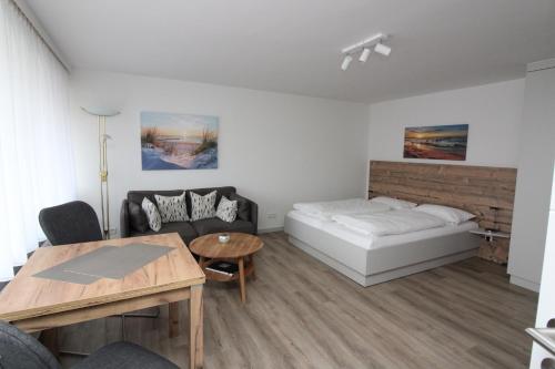 a living room with a bed and a table at Haus Nordseeresidenz Wohnung 63 in Westerland (Sylt)