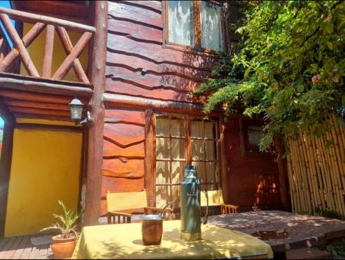 a table in front of a wooden building at Cábañas el Descanso in Mar del Plata