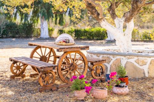 a wooden cart with a picnic table and a bench at Olive Studios Karpathos Studio #1 in Karpathos Town
