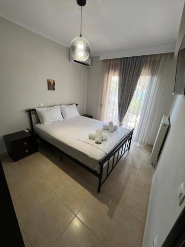 a bedroom with a bed with two towels on it at Metaxenia's house 101 in Nea Skioni