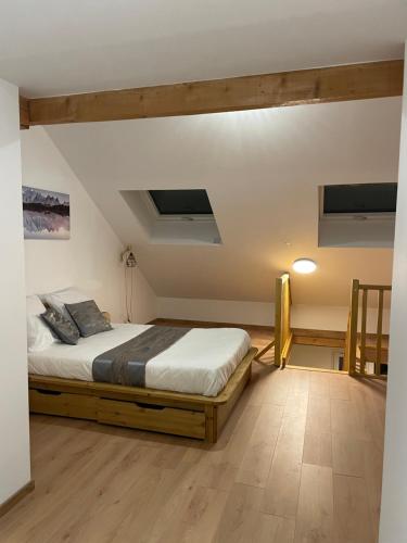 a bedroom with a large bed in a room at les Gites de l’E.D.E. in Saint-Léger-les-Mélèzes