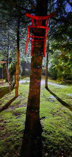 a red chair sitting on top of a tree at Flamignano relax e natura in Tossicia