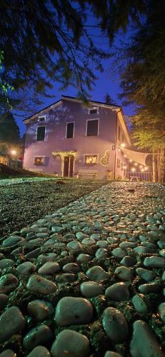 a large house with a cobblestone street at night at Flamignano relax e natura in Tossicia
