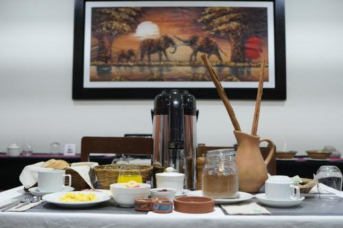 a table with breakfast foods and a coffee maker at Colca Canyon Hotel by PERU HTL in Chivay