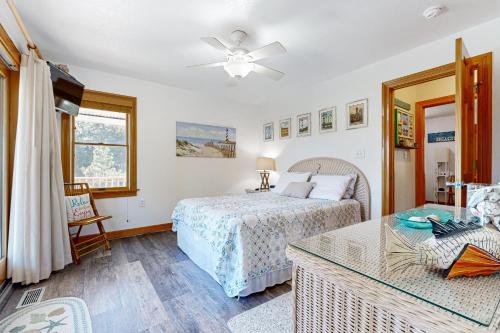a bedroom with a bed and a table at Play Time in Waves