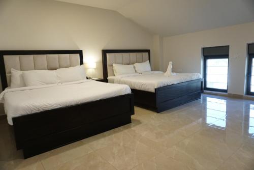 a bedroom with two beds in a room at Mizirawi Historic Hotel in Ramallah