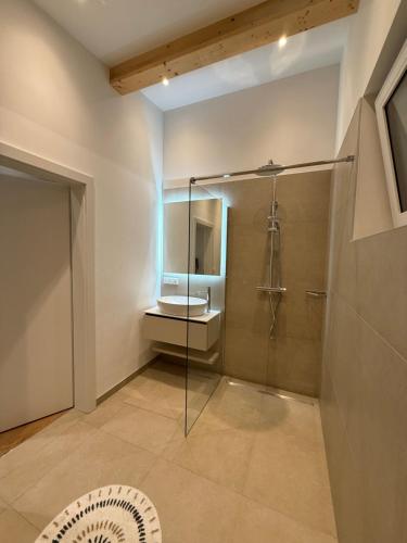 a bathroom with a shower and a toilet at MiHome - modern Living in Rottenmann