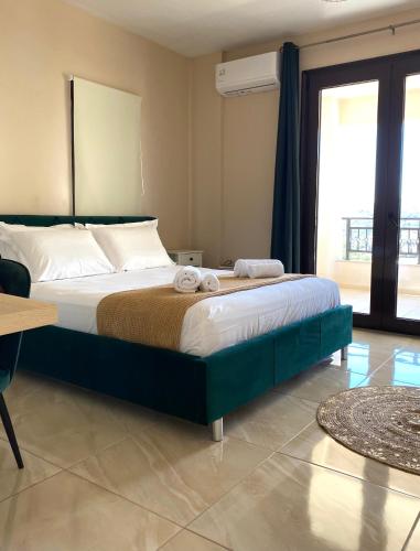 a bedroom with a large bed with towels on it at Mons Apartments in Spílion