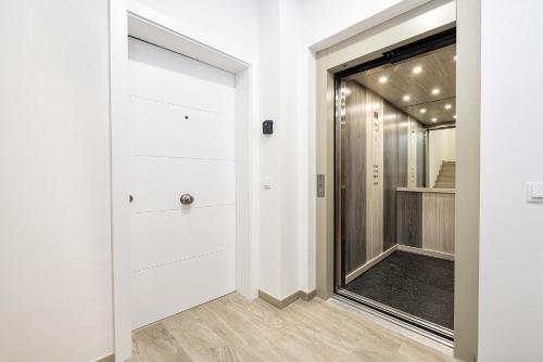 a door leading to a walk in closet with a mirror at La Marquesa Ten Suites Canteras in Las Palmas de Gran Canaria