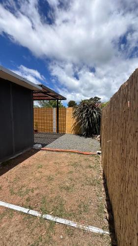a wooden fence with a gate and a fence at Casitas Atlántida in Atlántida