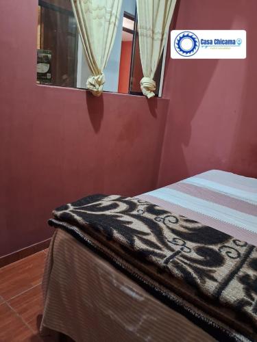 a room with a bed with a zebra blanket on it at Casa Chicama in Puerto Chicama