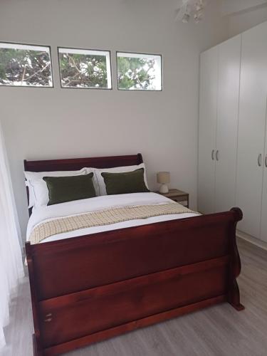 a bedroom with a large bed with four windows at Chuu's Cosy Place in East London