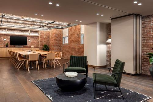 a room with a table and chairs and a dining room at Arlo Washington DC in Washington