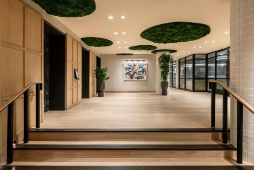 a hallway in a building with plants on the ceilings at Arlo Washington DC in Washington