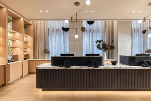 a lobby with a reception desk in a building at Arlo Washington DC in Washington