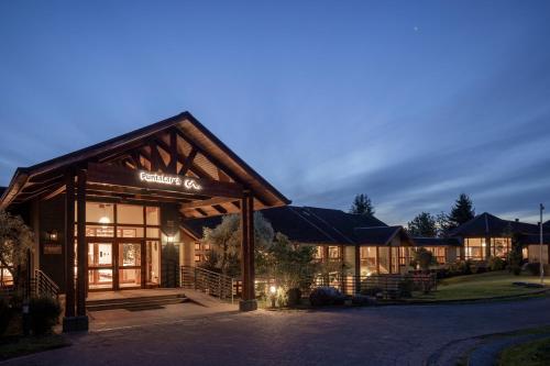 a building with a sign on the front of it at Hotel y Cabañas Punta Larga - Caja Los Andes in Frutillar
