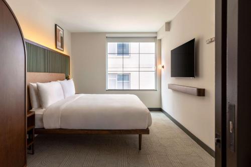 a hotel room with a bed and a window at Arlo Washington DC in Washington