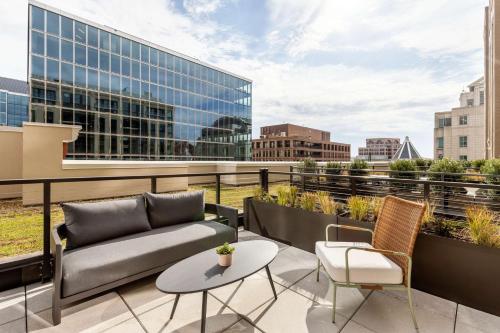 a balcony with a couch and chairs and a table at Arlo Washington DC in Washington