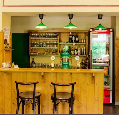 a bar with two stools in front of a counter at Apartmány U Šťastných in Cerny Dul