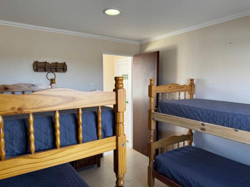 a bedroom with two bunk beds in a room at Posada Ruta 40 in Monte Dinero