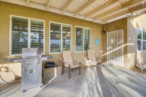 a patio with chairs and a table in a building at 1 Mi to Coachella Indio Home with Community Perks! in Indio