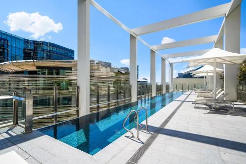 a swimming pool on the roof of a building at Urban Bliss 2BR Abode - Luxury丨Comfort丨Parking in Sydney