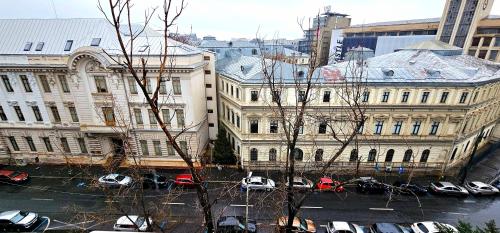 a view of a city with cars parked in a parking lot at Apartament Victoriei - Centru in Bucharest
