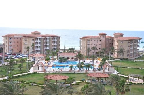 an aerial view of a resort and the ocean at Ajami Hotel Armed Forces Apartments in Alexandria