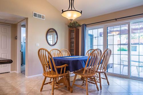 a dining room with a blue table and chairs at Cozy House Pool Spa Tennis & Pickleball Courts in Tempe