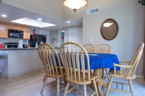 a dining room with a blue table and chairs at Cozy House Pool Spa Tennis & Pickleball Courts in Tempe