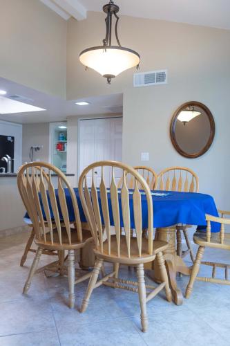 a dining room with a blue table and chairs at Cozy House Pool Spa Tennis & Pickleball Courts in Tempe
