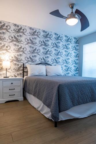 a bedroom with a bed and a blue wall at Cozy House Pool Spa Tennis & Pickleball Courts in Tempe