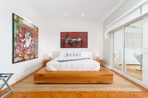 a bedroom with a bed and a large window at Blue Roatan Resort in West Bay