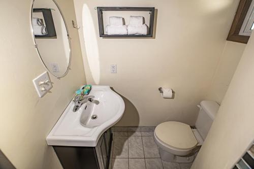 a bathroom with a sink and a toilet at 2 Coco Locos at Sunset in Seine Bight Village