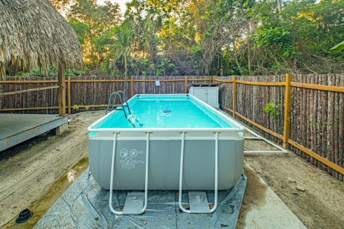 a hot tub in a yard next to a wooden fence at 2 Coco Locos at Sunset in Seine Bight Village