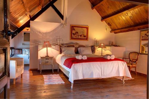 a bedroom with a large bed with two lamps on it at Reservaloen Hacienda las Marciagas in Benacazón