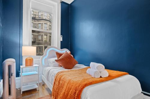 a blue bedroom with a bed with towels on it at Vintage Luxe NY - Designer Lofts & Apartments NYC in New York